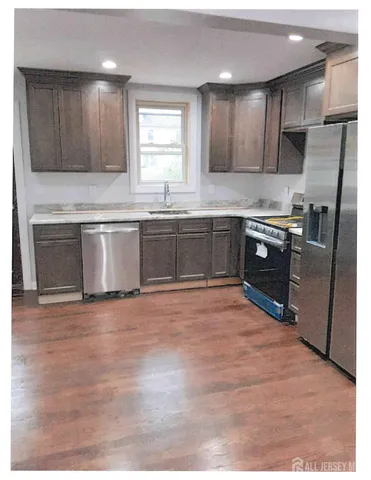 a open kitchen with granite countertop a stove top oven sink and cabinets