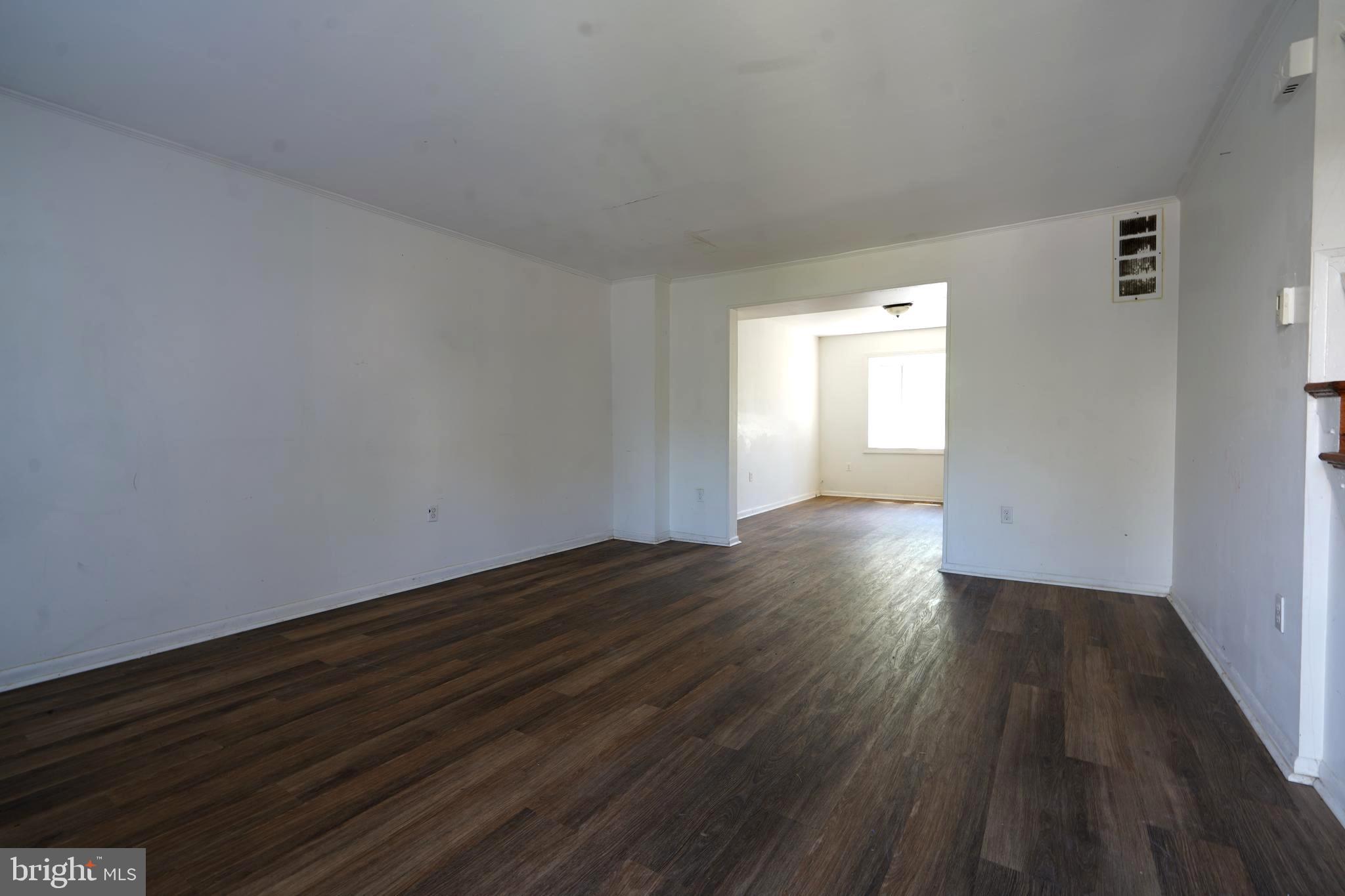 12836 Claxton Drive, Unit 4E Laurel, MD 20708 - Photo 5 of 13 a view of an empty room with wooden floor and a window