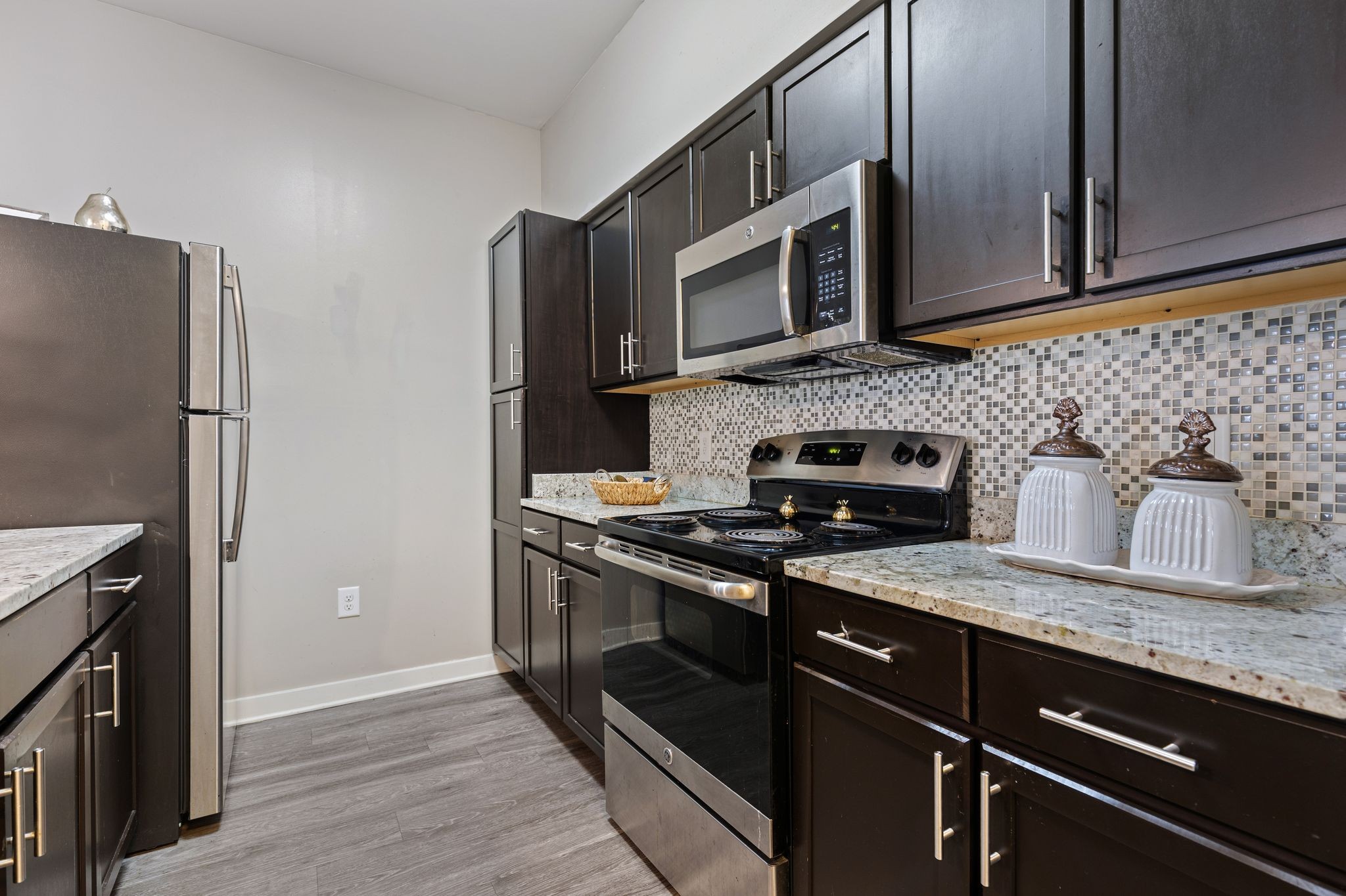 410 Rosedale Avenue, Unit 302 Nashville, TN 37211 - Photo 4 of 13 a kitchen with stainless steel appliances granite countertop a stove microwave and refrigerator