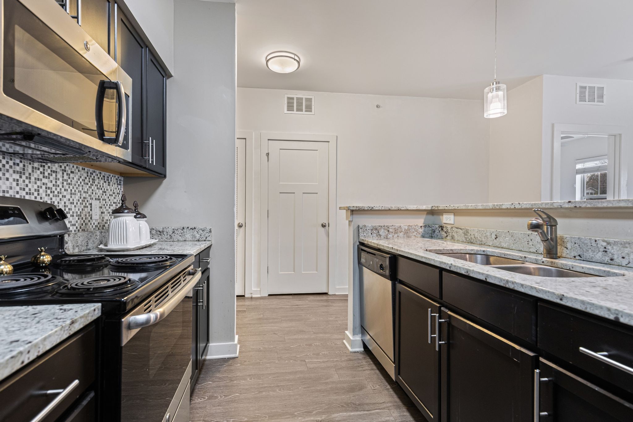 410 Rosedale Avenue, Unit 302 Nashville, TN 37211 - Photo 5 of 13 a kitchen with a sink stove and cabinets