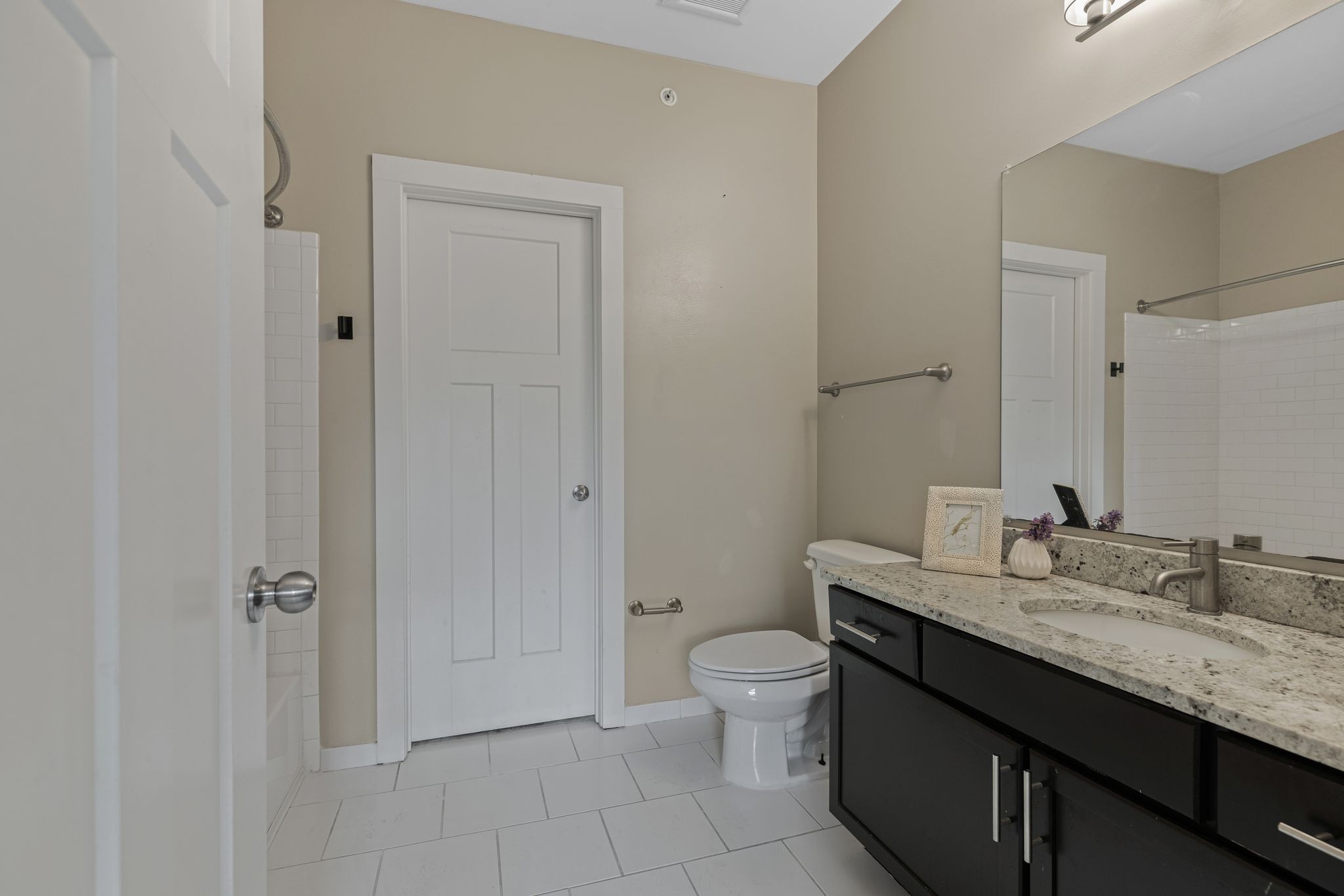 410 Rosedale Avenue, Unit 302 Nashville, TN 37211 - Photo 9 of 13 a bathroom with a granite countertop sink a toilet and a mirror