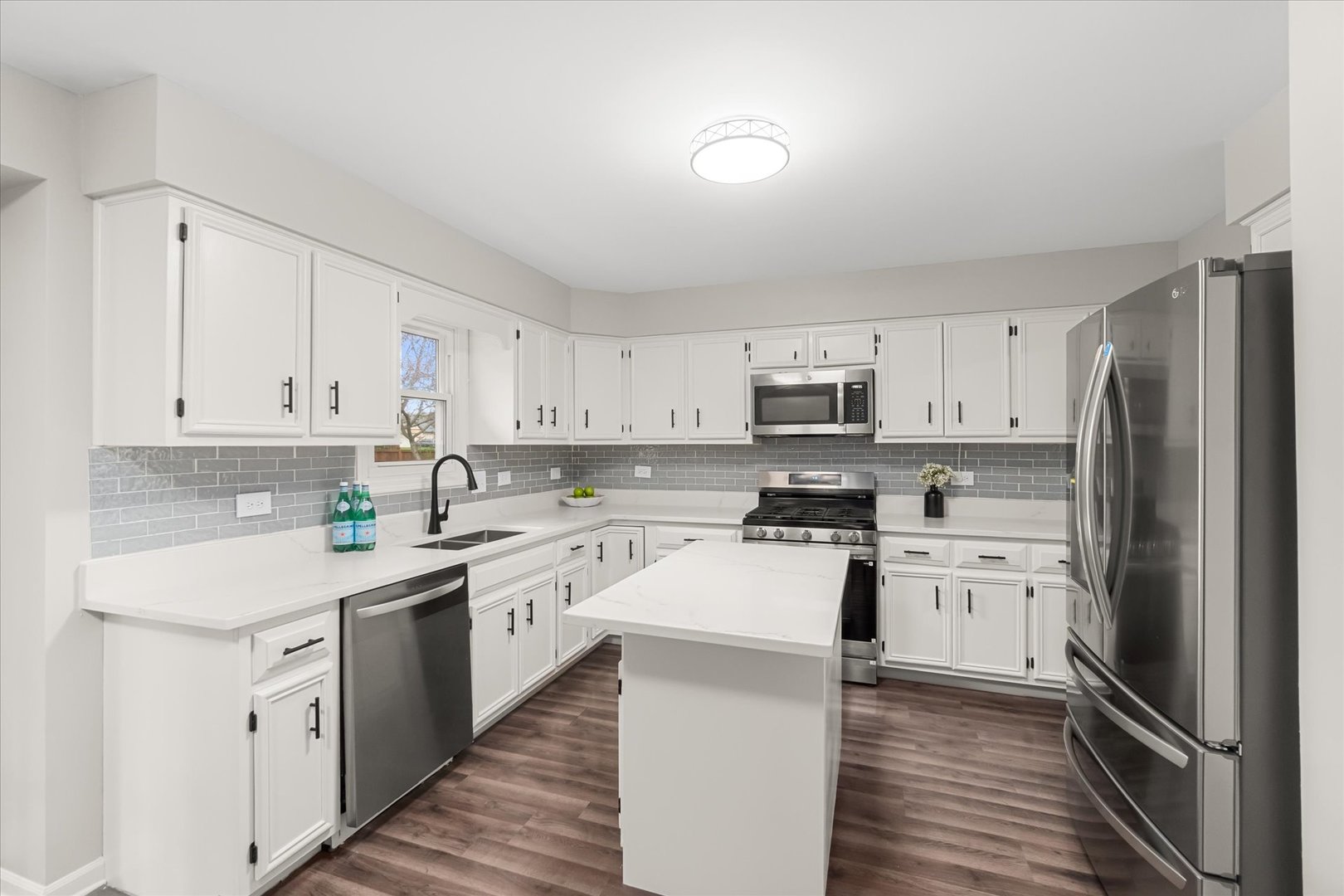 1763 Frost Lane Naperville, IL 60564 - Photo 7 of 46 a kitchen with cabinets stainless steel appliances a sink and wooden floor