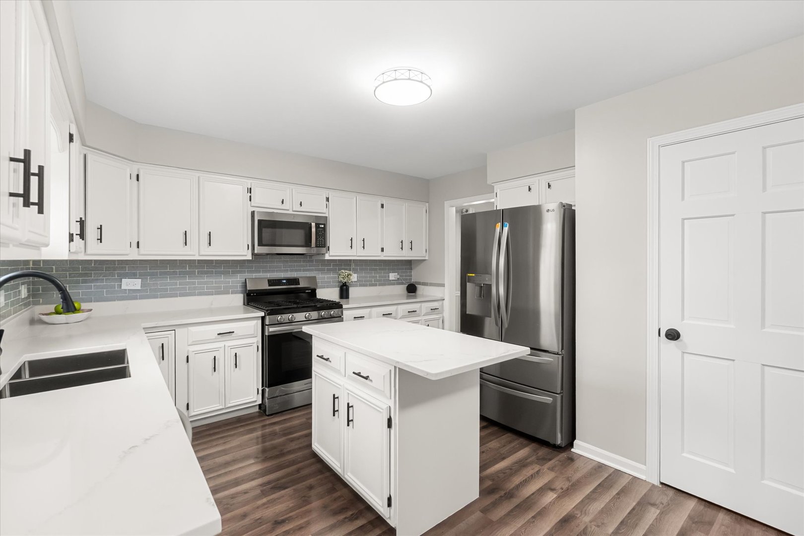 1763 Frost Lane Naperville, IL 60564 - Photo 8 of 46 a kitchen with stainless steel appliances white cabinets and wooden floors