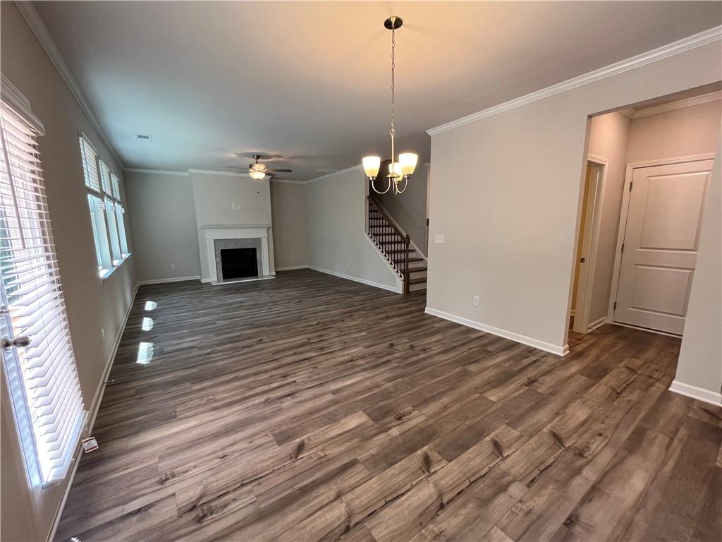 4524 Ajo Walk Atlanta, GA 30331 - Photo 11 of 40 a view of a room with wooden floor staircase and a kitchen