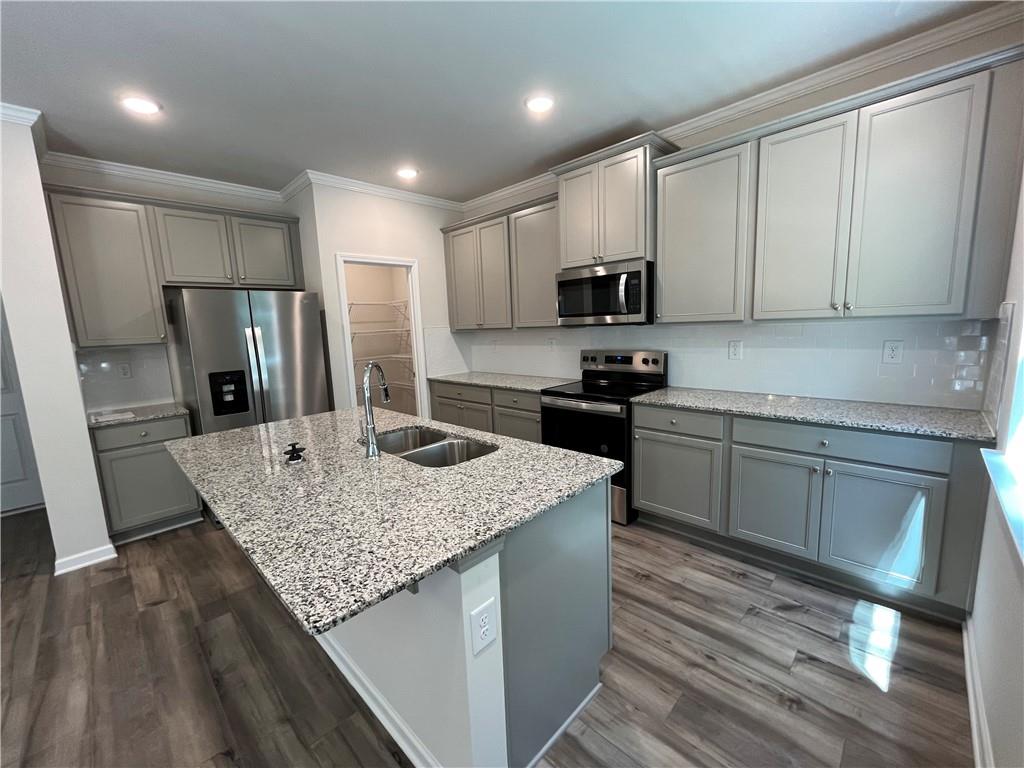 4524 Ajo Walk Atlanta, GA 30331 - Photo 12 of 40 a kitchen with stainless steel appliances granite countertop a sink refrigerator and microwave