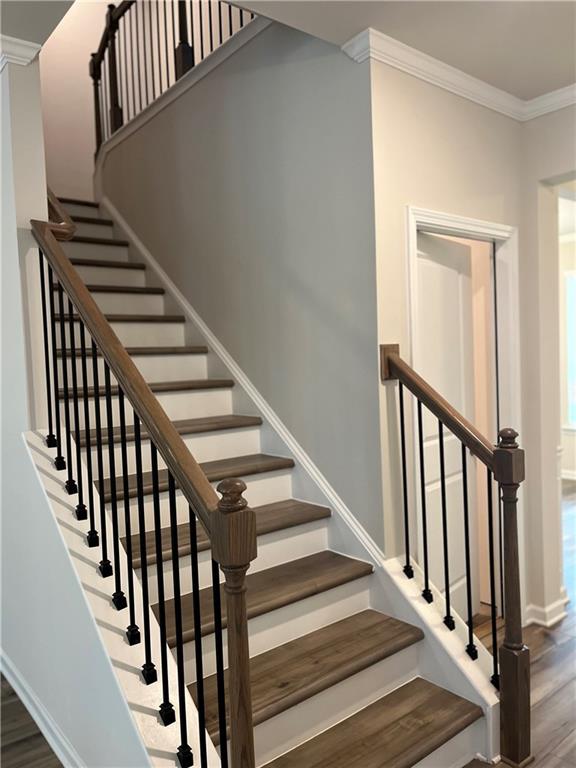 4524 Ajo Walk Atlanta, GA 30331 - Photo 17 of 40 a view of staircase with wooden floor and white walls