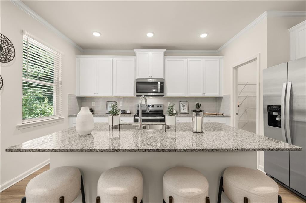 4524 Ajo Walk Atlanta, GA 30331 - Photo 2 of 40 a kitchen with granite countertop kitchen island sink refrigerator and cabinets