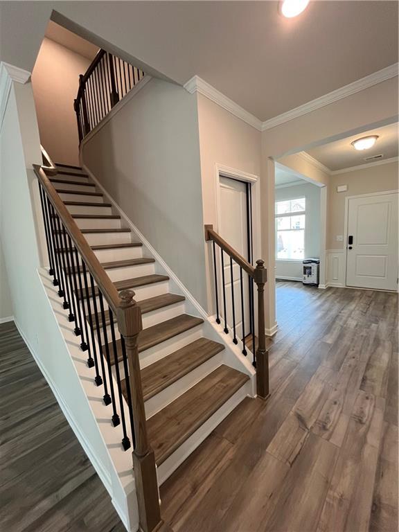 4524 Ajo Walk Atlanta, GA 30331 - Photo 29 of 40 a view of a hallway with wooden floor and stairs