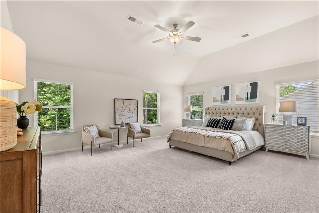 4524 Ajo Walk Atlanta, GA 30331 - Photo 4 of 40 a spacious bedroom with a bed and a chandelier