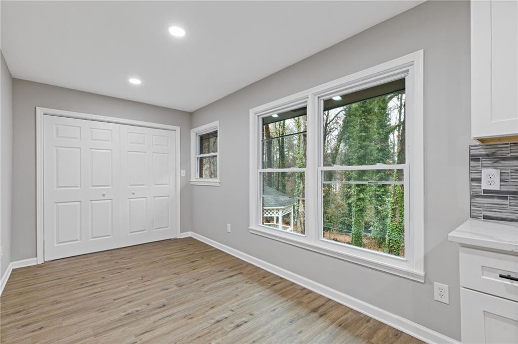 2224 Hudson Drive Southwest Lilburn, GA 30047 - Photo 11 of 31 a view of empty room with wooden floor and fan