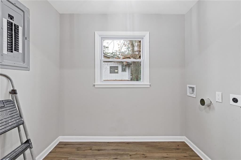 2224 Hudson Drive Southwest Lilburn, GA 30047 - Photo 12 of 31 a view of an empty room with wooden floor and a window