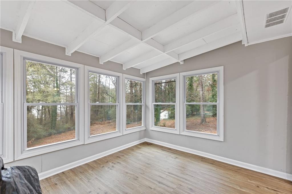 2224 Hudson Drive Southwest Lilburn, GA 30047 - Photo 13 of 31 a view of an empty room with wooden floor and a window
