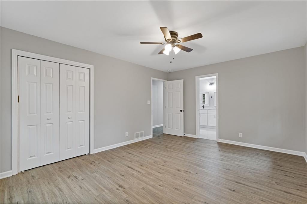 2224 Hudson Drive Southwest Lilburn, GA 30047 - Photo 18 of 31 a view of an empty room with wooden floor