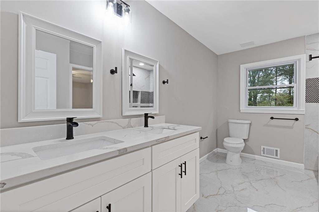 2224 Hudson Drive Southwest Lilburn, GA 30047 - Photo 19 of 31 a bathroom with a sink and a toilet