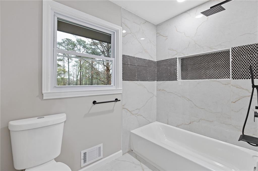 2224 Hudson Drive Southwest Lilburn, GA 30047 - Photo 20 of 31 a bathroom with a toilet a sink and bathtub