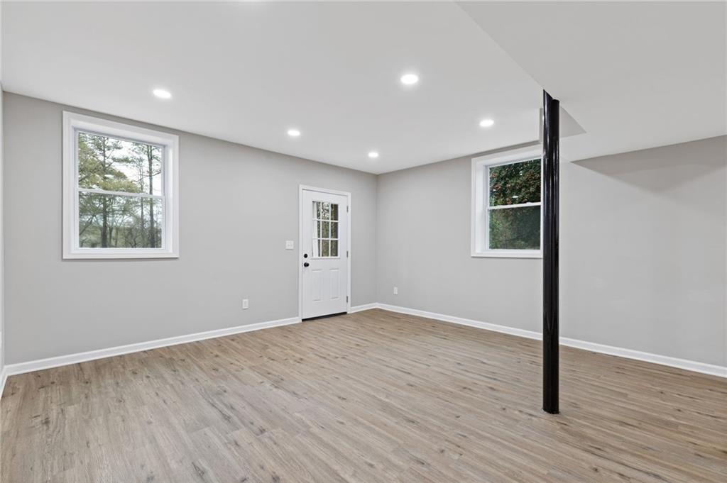 2224 Hudson Drive Southwest Lilburn, GA 30047 - Photo 21 of 31 a view of an empty room with wooden floor and a window
