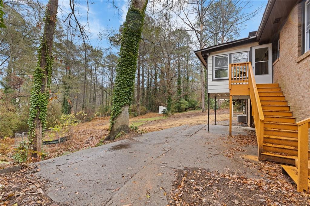 2224 Hudson Drive Southwest Lilburn, GA 30047 - Photo 28 of 31 a backyard of a house with table and chairs