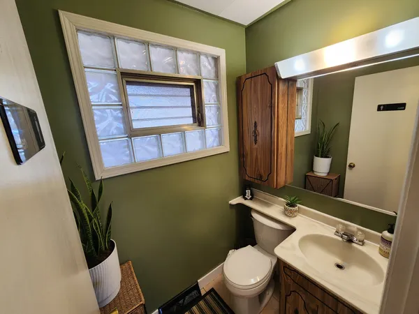 a bathroom with a toilet sink and mirror