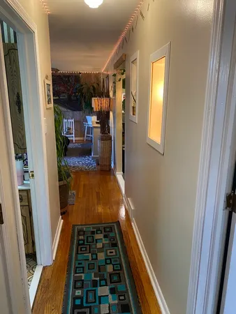 a room with wooden floor and furniture