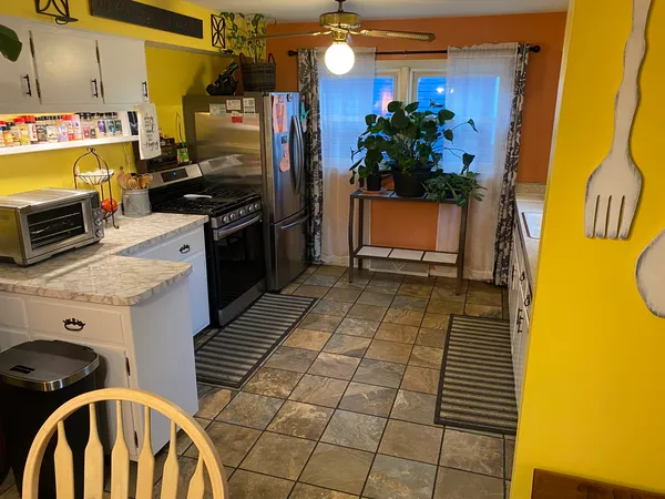 a kitchen with a sink a stove and refrigerator