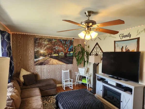 a living room with furniture and a flat screen tv
