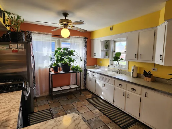a kitchen with sink and cabinets