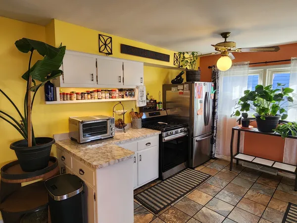 a kitchen with a sink appliances and cabinets