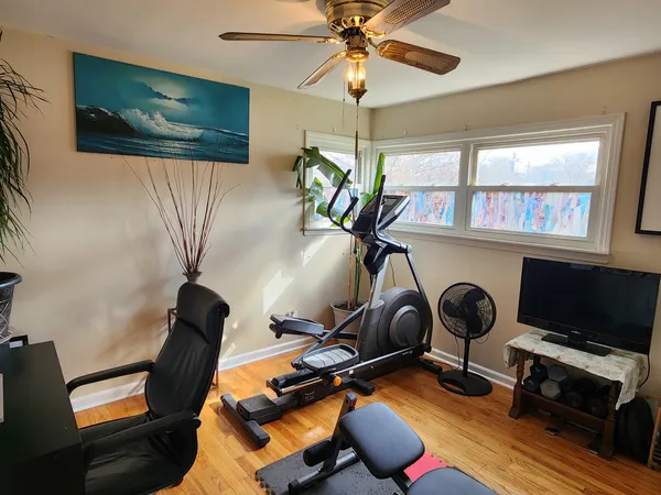 a room with gym equipment and a flat screen tv