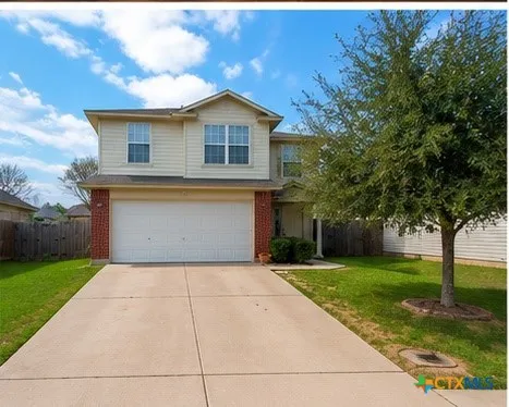 a view of a house with yard and tree s