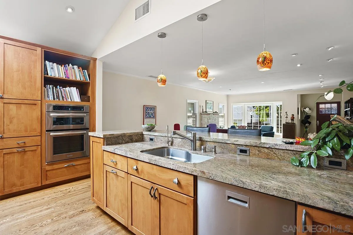 4329 Arista Street San Diego, CA 92103 - Photo 13 of 44 a kitchen with granite countertop a sink and a refrigerator