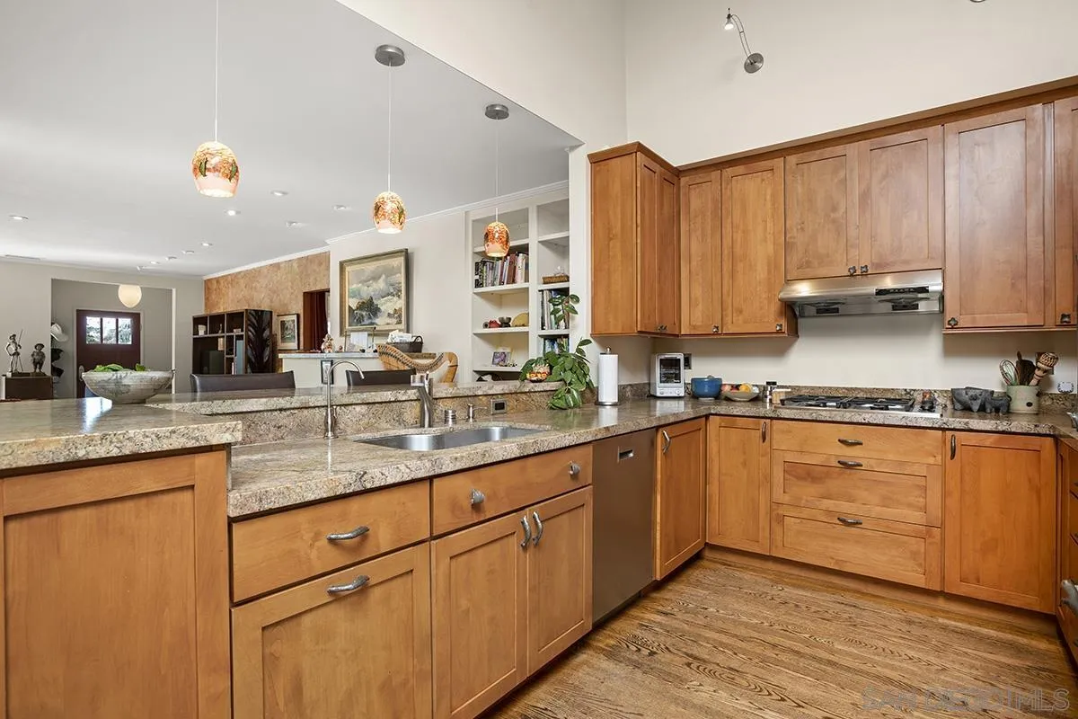 4329 Arista Street San Diego, CA 92103 - Photo 14 of 44 a kitchen with stainless steel appliances granite countertop wooden cabinets a sink and dishwasher