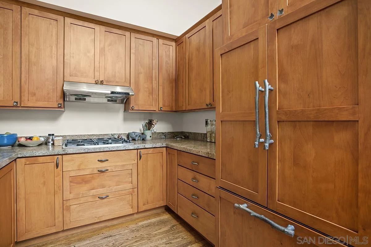 4329 Arista Street San Diego, CA 92103 - Photo 15 of 44 a kitchen with stainless steel appliances granite countertop white cabinets and sink