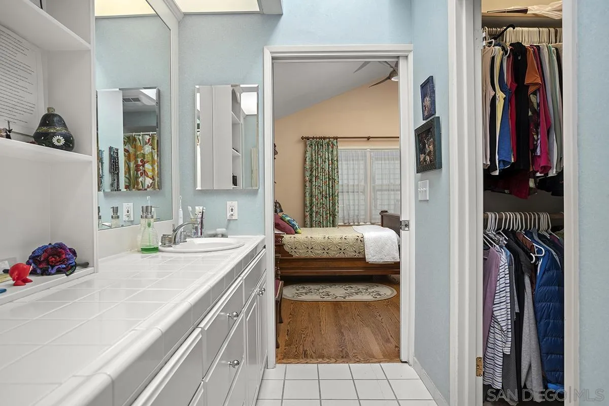 4329 Arista Street San Diego, CA 92103 - Photo 24 of 44 a en suite bathroom with a granite countertop sink and a mirror
