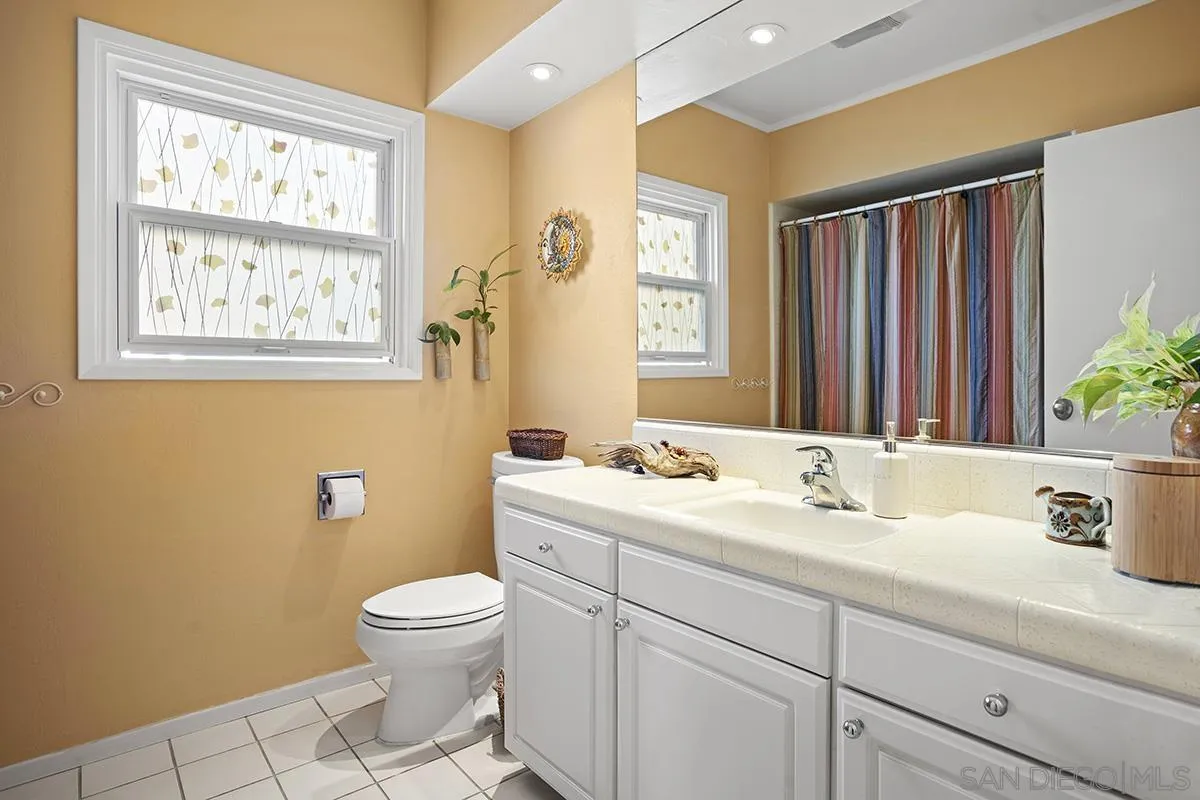 4329 Arista Street San Diego, CA 92103 - Photo 27 of 44 a bathroom with a toilet a sink and a mirror