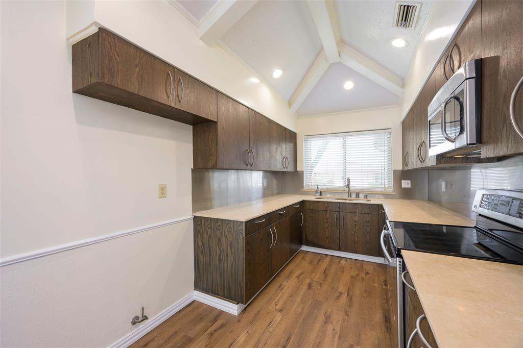 6512 Mc Cormick Ranch Court Plano, TX 75023 - Photo 15 of 29 a kitchen with stainless steel appliances a sink and a stove top oven