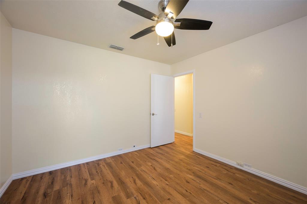 6512 Mc Cormick Ranch Court Plano, TX 75023 - Photo 19 of 29 an empty room with wooden floor and ceiling fan