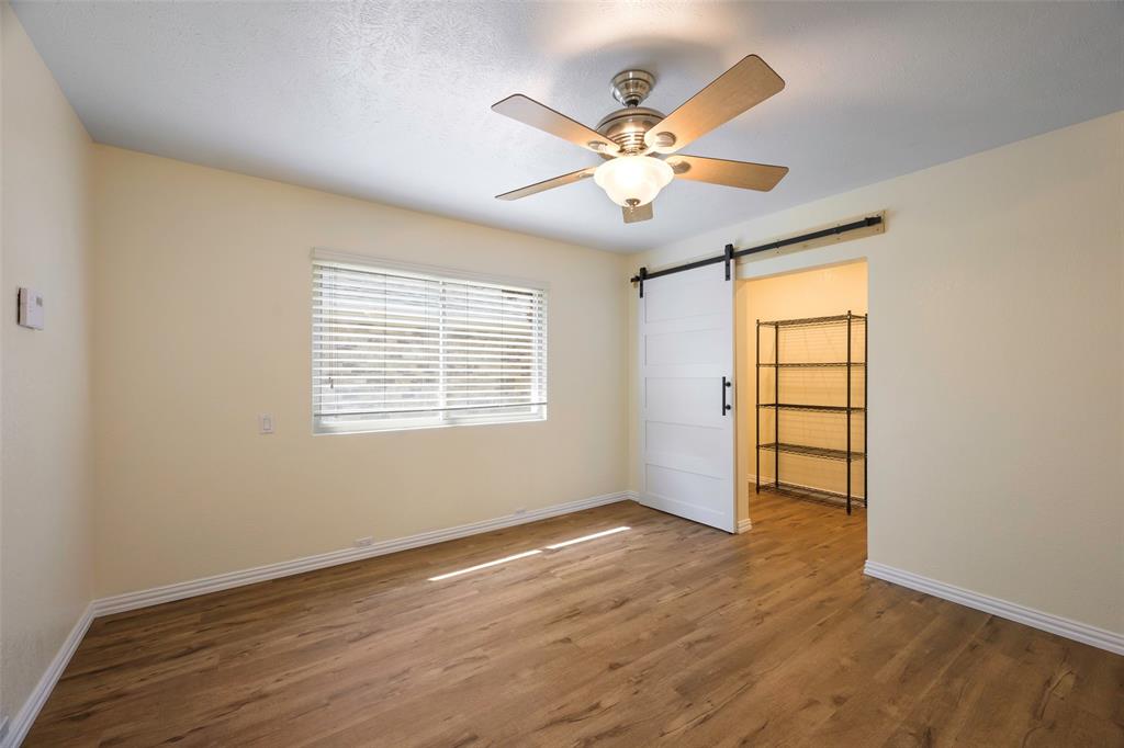 6512 Mc Cormick Ranch Court Plano, TX 75023 - Photo 22 of 29 a view of an empty room with wooden floor and a window