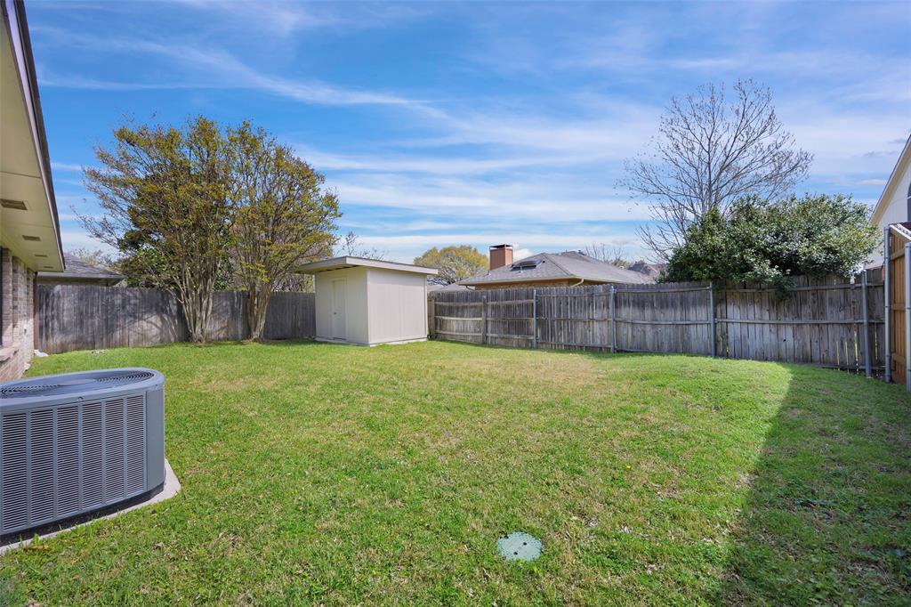 6512 Mc Cormick Ranch Court Plano, TX 75023 - Photo 27 of 29 a view of a backyard with tree and wooden fence
