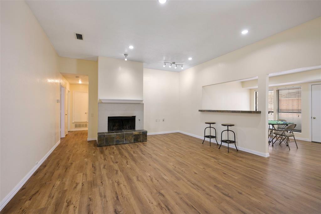 6512 Mc Cormick Ranch Court Plano, TX 75023 - Photo 8 of 29 a view of a kitchen with furniture and a fireplace