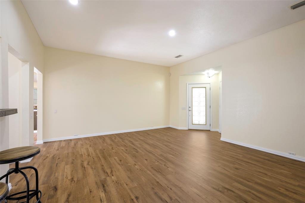 6512 Mc Cormick Ranch Court Plano, TX 75023 - Photo 10 of 29 a view of an empty room with wooden floor and a window