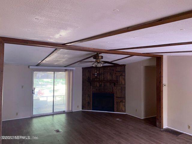 2955 Hilltop Road St. Augustine, FL 32086 - Photo 4 of 9 a view of a hallway with wooden floor and a window