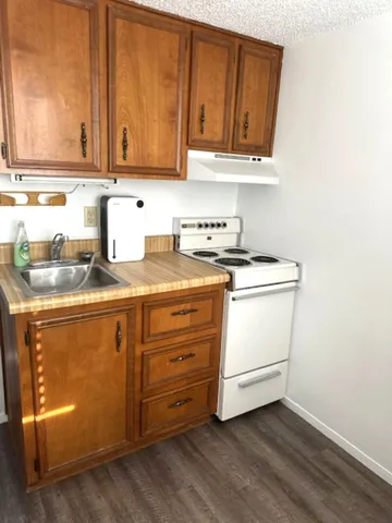 a kitchen with granite countertop cabinets and white appliances