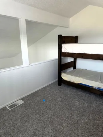 a bedroom with a bed and a window