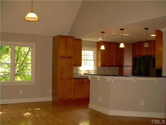 208 Avon Drive Raleigh, NC 27608 - Photo 4 of 4 a view of a kitchen with a refrigerator a sink and a window