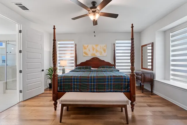 a room with wooden floor and windows