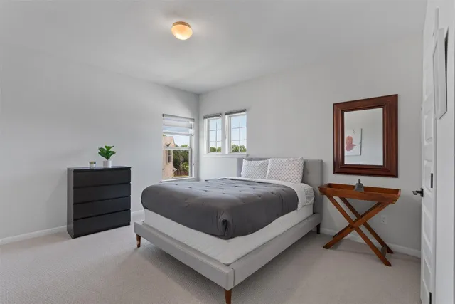 a spacious bedroom with a bed and window