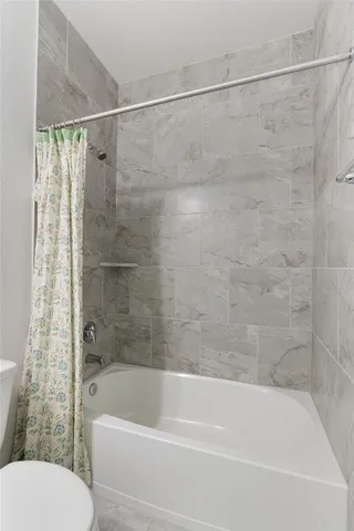 a bathroom with a shower and a toilet