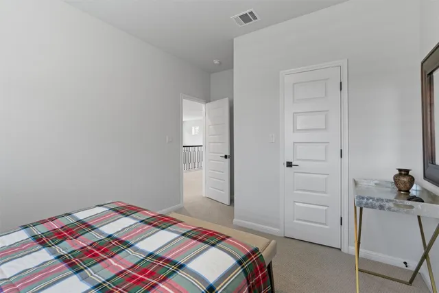 a bedroom with a bed and cabinets