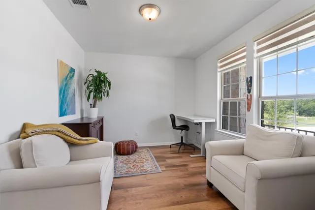 a living room with furniture and a potted plant