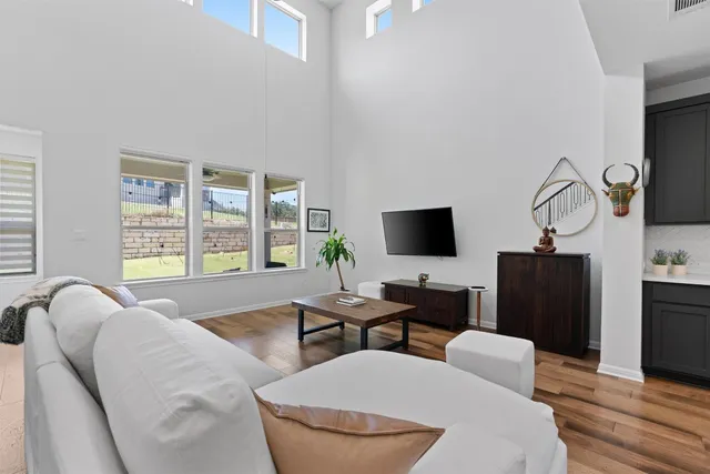 a hotel room with furniture a flat screen tv and a large window